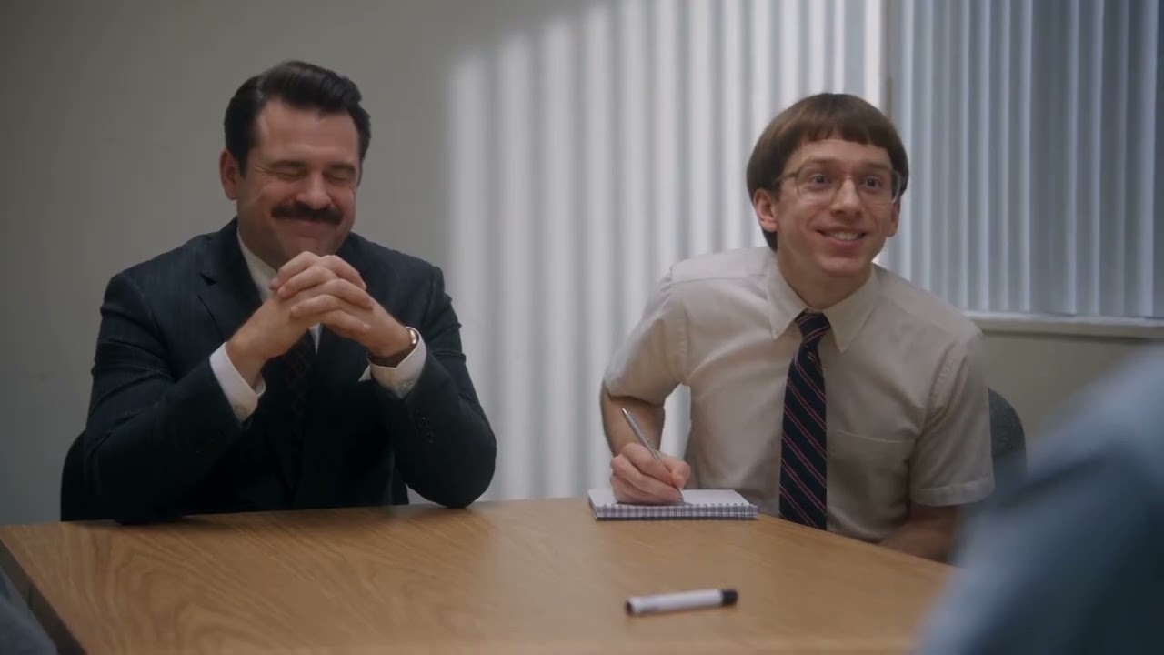 Still from Overqualified — A job interview. The candidate has read everything ever written. They ask him to spell strawberry.